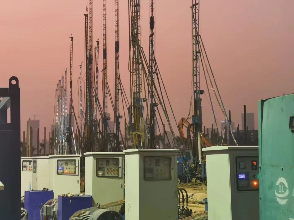 Control cabinets in front of a line of jet grouting rigs